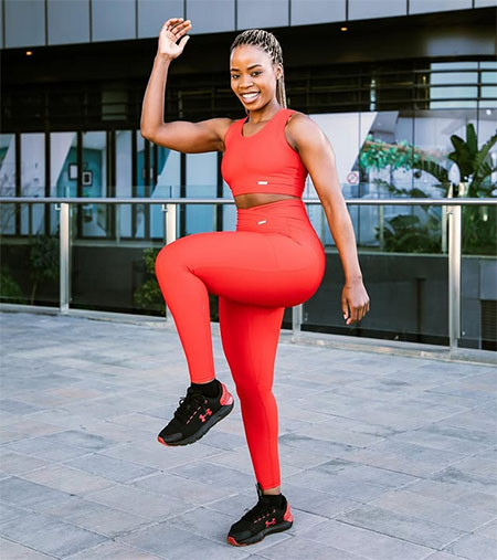 Young African woman stretching and wellness practice outdoors